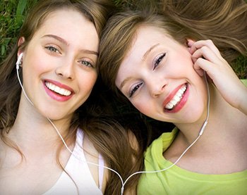 Two young women smiling after wisdom tooth extraction in Orange California