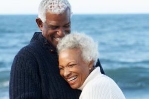 Man and woman smiling after receiving oral surgery in Orange California