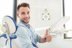 man giving thumbs up at his dental checkup 