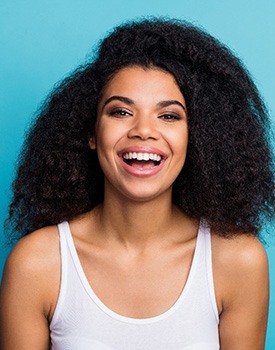 Woman smiling after visiting cosmetic dentist in Orange CA