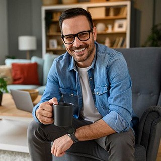 a man smiling with his new dental bridges 
