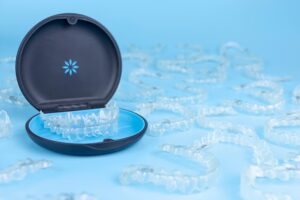 Aligners in case surrounded by multiple other clear aligners