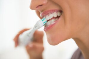 zoomed in view of a person brushing their teeth