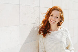 Woman smiling outside.