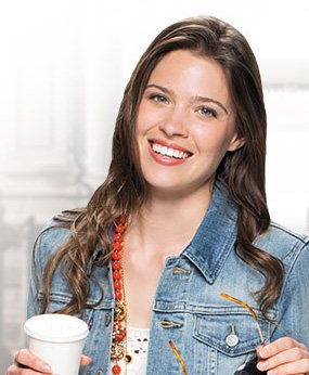 Woman sharing beautiful smile thanks to Orange California Invisalign clear braces
