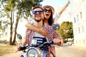 Man and woman smiling after receiving same day dental crowns in Orange California