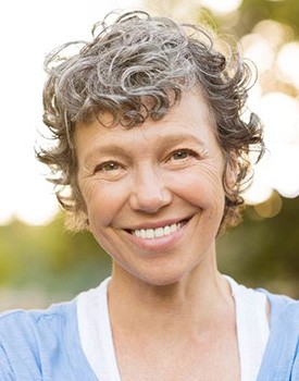 woman smiling after getting dental implants in Orange