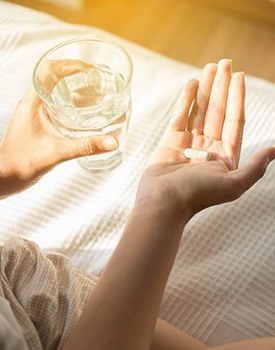 taking pain medication after dental implant surgery in Orange