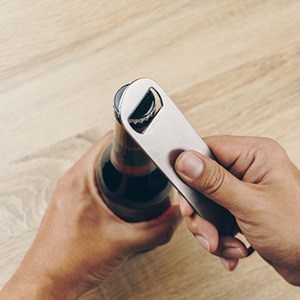 Closeup of patient using bottle opener