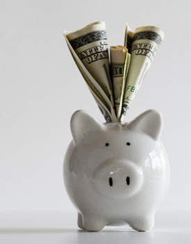 White piggy bank with dollar bills sticking out of it
